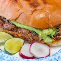 Tortas · Shredded beef torta includes; cheese, guacamole, cilantro and onion.