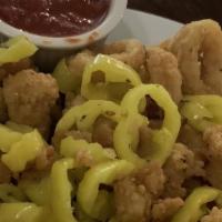 Calamari · Calamari rings, breaded and lightly fried with pepperoncinis. Tossed with either garlic butt...