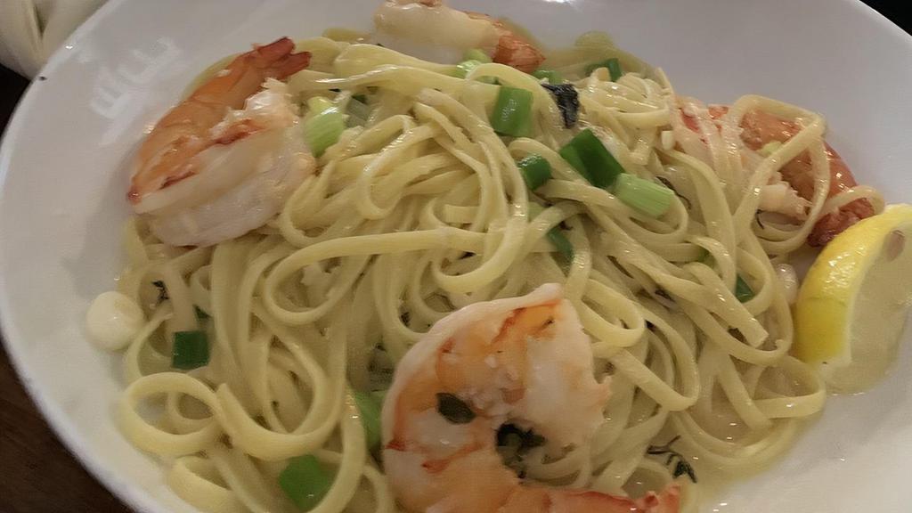 Shrimp Scampi · Five jumbo shrimp served in a white wine garlic butter sauce with scallions over a bed of linguine pasta.