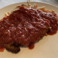 Parmigiana · Breaded chicken or veal cutlet topped with melted mozzarella cheese and marinara sauce. Serv...