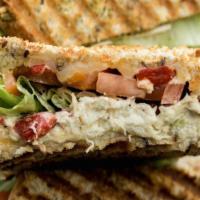 Chicken Salad Panini · Served on multi grain panini bread . Chicken salad, roasted red peppers, muenster chs, lettu...