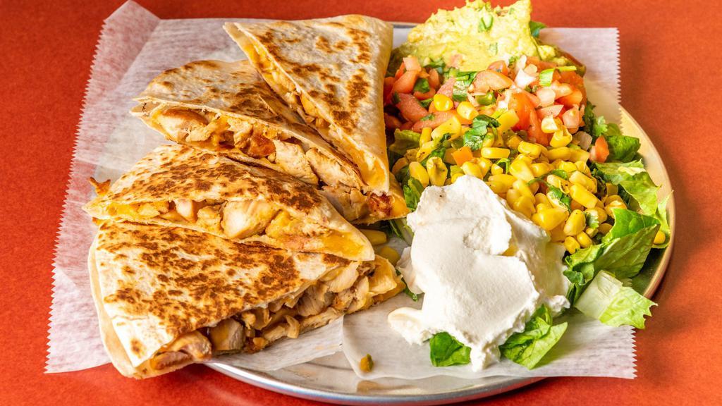 **Baja Quesadilla** · Grilled White or Wheat Flour Tortilla with cheese and choice of Meat. Choice of sides: lettuce, pico de gallo, corn salsa, sour cream, guacamole.                                                                          No meaning found for star sign.