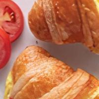 Breakfast Croissant · Scrambled eggs and your choice of bacon, turkey, sausage or ham and cheddar on a butter croi...