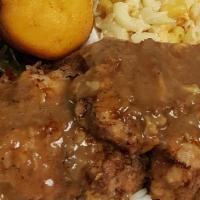 Smothered Pork Chops Plate · Comes with three sides and two pieces of cornbread.