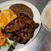 Carne Asada / Grilled Steak · Bistec a la parrilla con condimento especial servido con arroz, frijoles, dos tortillas de m...
