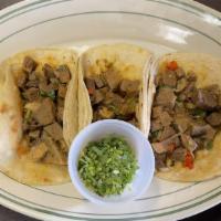 Tacos De Lengua (3) / Tongue Tacos (3) · Tacos de lengua de res servidos con cilantro y cebollas. / Beef tongue tacos served with cil...