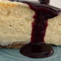 New York Cheesecake · Creamy cheesecake with graham cracker crust with optional triple berry sauce.