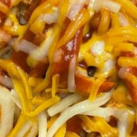 Red Chili Cheese Fries · Hot crispy fries covered is Smokey savory New Mexico style red chili sauce. Topped with shre...