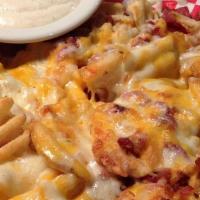 Three Cheese Fries · Super crispy waffle cut fries covered in melted Monterey jack, cheddar, and pepper jack chee...