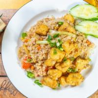 Thai Fried Rice · Stir-fried with white rice in Thai soy sauce, garlic, egg, onion, carrot, tomato and green o...