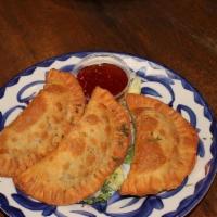 Chicken Empanadas · Flaky pastry stuffed with cheese and
seasoned chicken, fried until golden brown.
Served with...