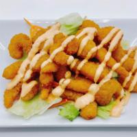 Shrimp Popcorn · Crispy shrimp tossed with spicy mayo ailoi sauce and served on bed of iceberg lettuce.
