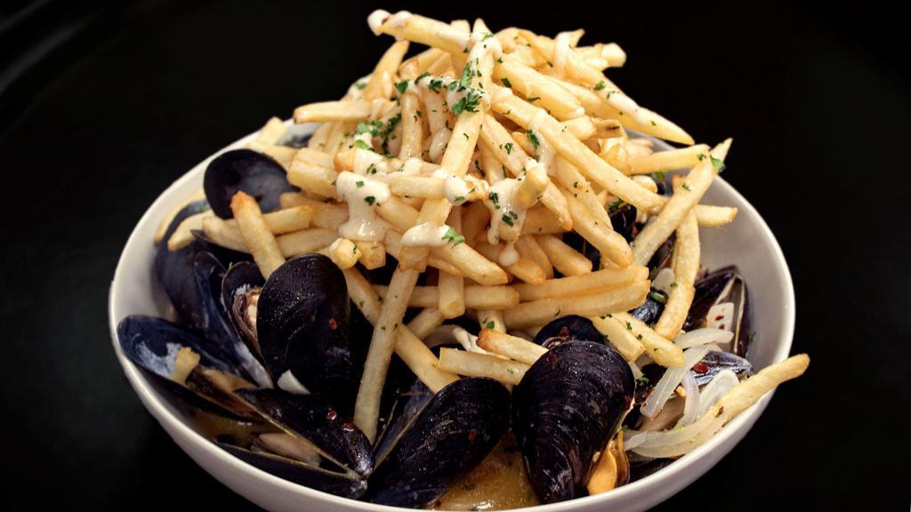 Pan Roasted Mussels · Served with a pile of fries topped with a lemon garlic aioli
