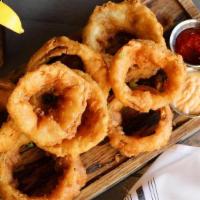 Beer Battered Onion Rings · Sweet yellow onions, farmhouse saison beer batter, house made beer salt, scallions, served w...