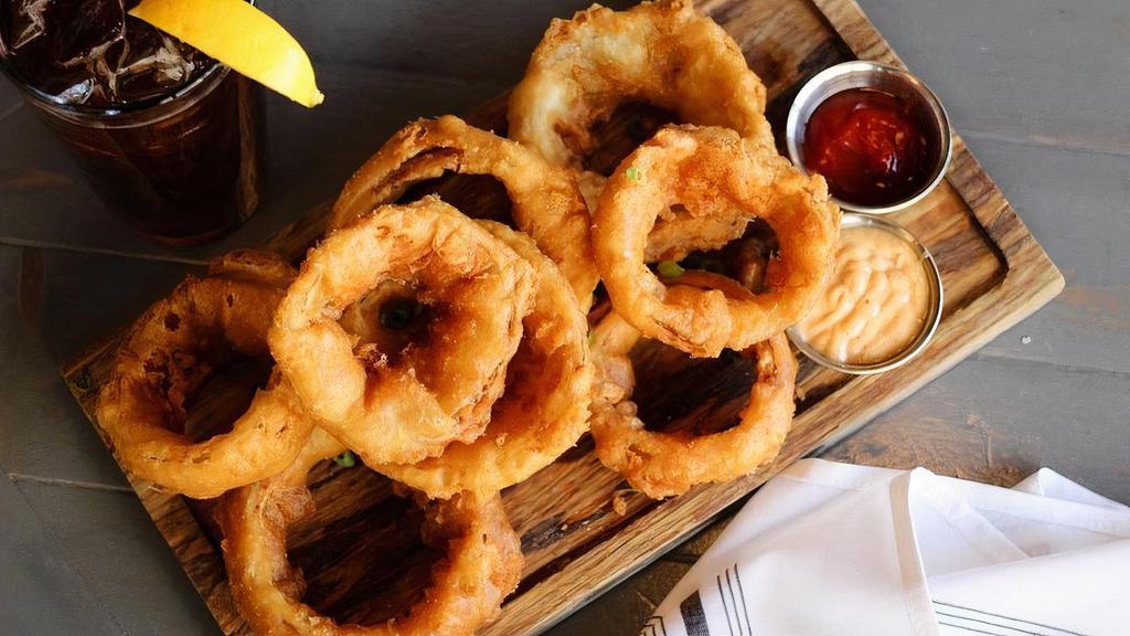 Beer Battered Onion Rings · Sweet yellow onions, farmhouse saison beer batter, house made beer salt, scallions, served with special sauce