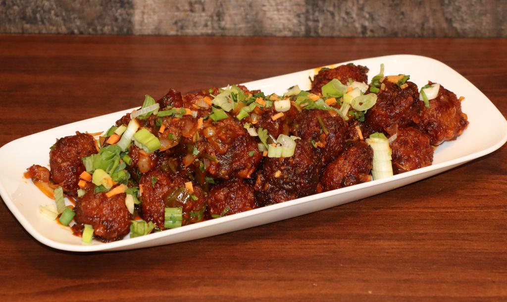 Vegetable Manchurian · Coated in a Manchurian sauce made from scratch (ginger and garlic, soy sauce, chili sauces, and vinegar), this Indo-Chinese appetizer is always a favorite. Did it come from the land of the Manchus or someone's kitchen in Kolkata? All we know is... IT IS DELISH!