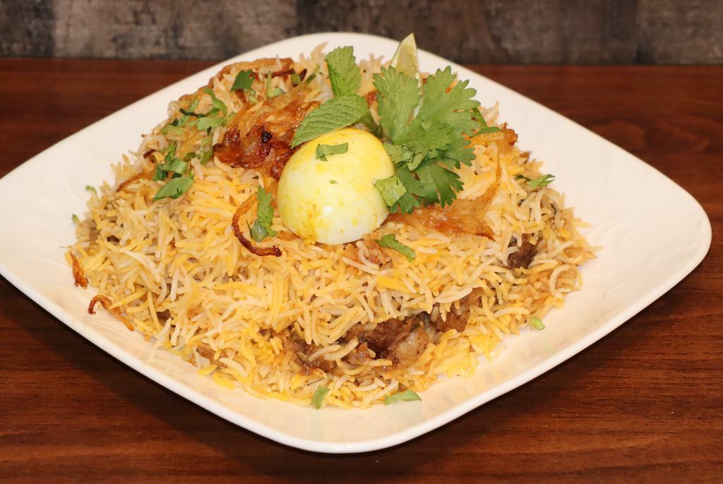 Goat Biryani · An Indian dish made to be thoroughly enjoyed by anyone who eats it. Made with the best basmati rice and a perfect blend of spices, cooked in original dum style.