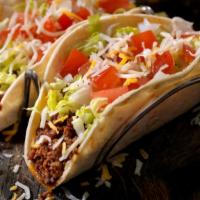 El Pobricito · House made seasoned ground turkey taco with shredded cheese, diced tomato, red onions ad sou...