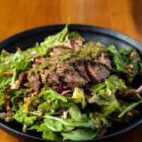 Grilled Bistro Steak Salad · Fire-roasted peppers, Maytag bleu cheese, mixed artisan lettuce and red onion. Served with t...