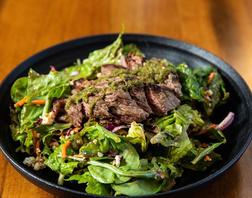 Grilled Bistro Steak Salad · Fire-roasted peppers, Maytag bleu cheese, mixed artisan lettuce and red onion. Served with two dressings: Argentinian steak sauce 