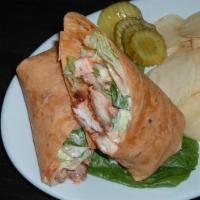 Buffalo Chicken Wrap · Buffalo chicken tenders all mixed in with greens and blue cheese dressing on a tomato basil ...