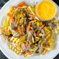 Beefed Up Cheese Fries · Order of our Factory Fries loaded with our cheddar cheese sauce, sliced Italian beef, and to...