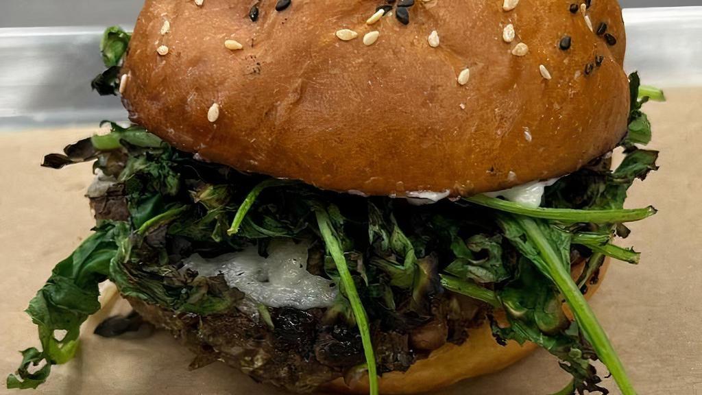 Hippie Burger · Veggie burger made with black eyed peas, black beans, and seasonal. vegetables. Served with charred kale, Turkish pickled fennel, garlic. toum, and a vegan mozzarella stacked on our house vegan bun.