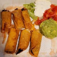 Taquitos · Shredded chicken or beef rolled in a crispy corn tortilla. Topped with sour cream and guacam...