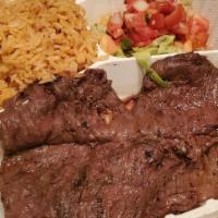 Carne Asada · Marinated beef skirt steak served with lettuce and pico de gallo.