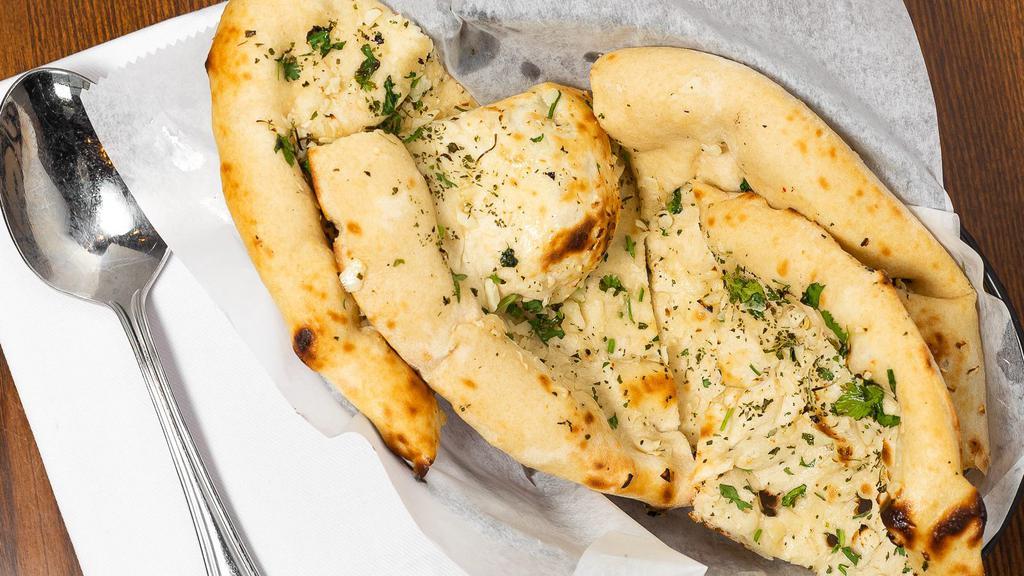 Garlic Naan · Leavened flatbread brushed with garlic butter.