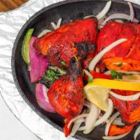 Tandoori Chicken · Mildly spiced chicken with a fiery hue. Chicken is marinated in yogurt and traditional tando...