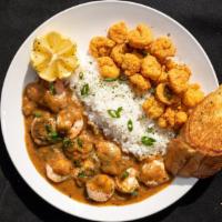 Crawfish Or Shrimp Etoufee Platter · Crawfish tails or shrimp served on a bed rice topped with etoufee, salad and bread.