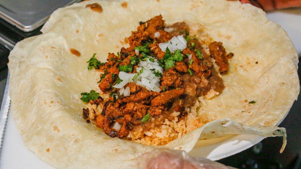 Burrito · Choice of meat+
Flour tortilla, beans, rice, cilantro , onion