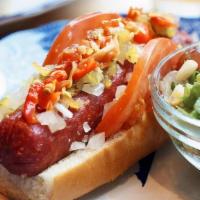 Chicago Dog · Layered with spicy brown mustard, tomato, onion, relish, and hot pickled peppers.