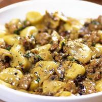 Sausage Mushroom Gnocchi · Fresh potato gnocchi tossed in a creamy, peppery amaretto sauce with spicy pork sausage and ...