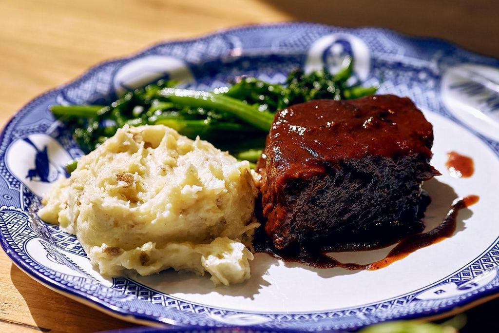 Slow-Braised Beef Short Rib · Braised in our signature broth, topped with our house-made BBQ sauce. Served with your choice of two sides.