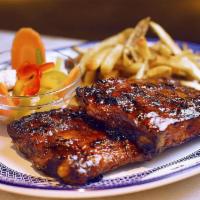 Bbq Pork Ribs · Dry-rubbed spare ribs topped with our BBQ sauce. Your choice of 2 sides.