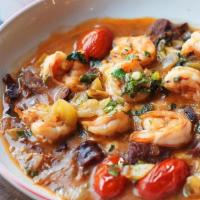 Shrimp & Grits, Andouille · Sautéed shrimp and andouille sausage cooked with green and red tomatoes in a slightly-spicy ...