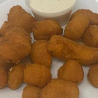 Battered Cheese Curds · White cheddar cheese curds covered in battered breading.