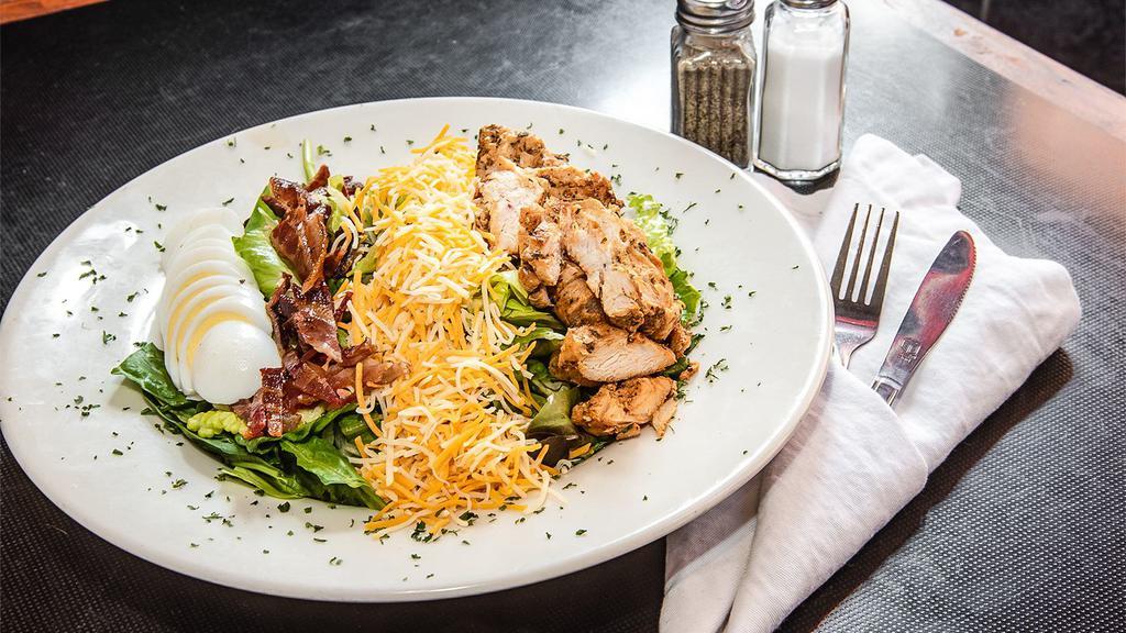 California Cobb · Grilled chicken, bacon, chopped eggs, tomato, and cheddar cheese on mixed greens.