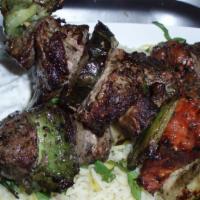 Marinated Lamb Kabobs · Tender lamb skewered with onions, mushrooms, bell peppers, zucchini, and tomato grilled over...