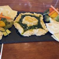 Hummus Board · Roasted vegetables, house-made pita bread, basil pesto, and honey.