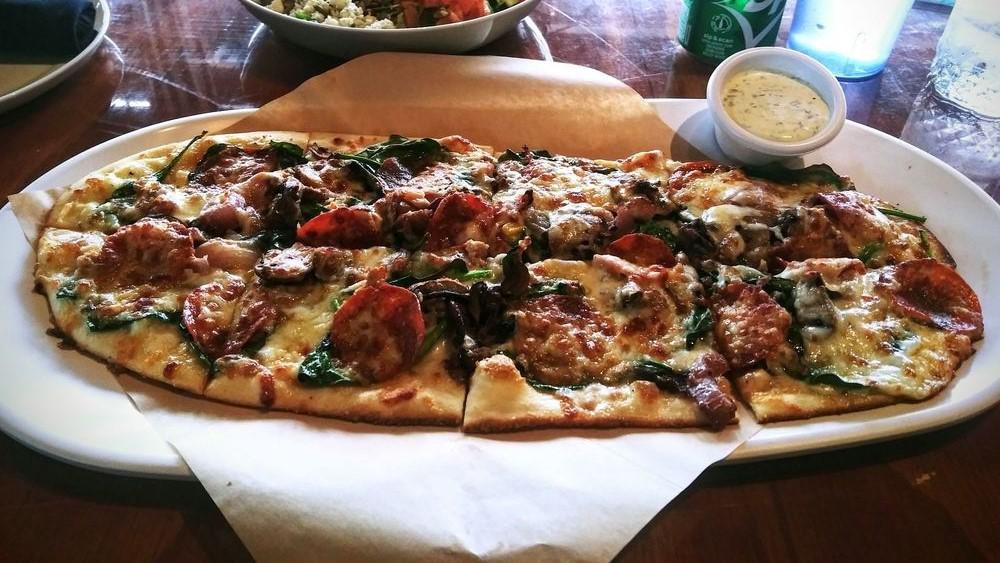 Paradise Pie · House white sauce, four cheese blend, spinach, pepperoni, crumbled Italian sausage, mushrooms, and red onions