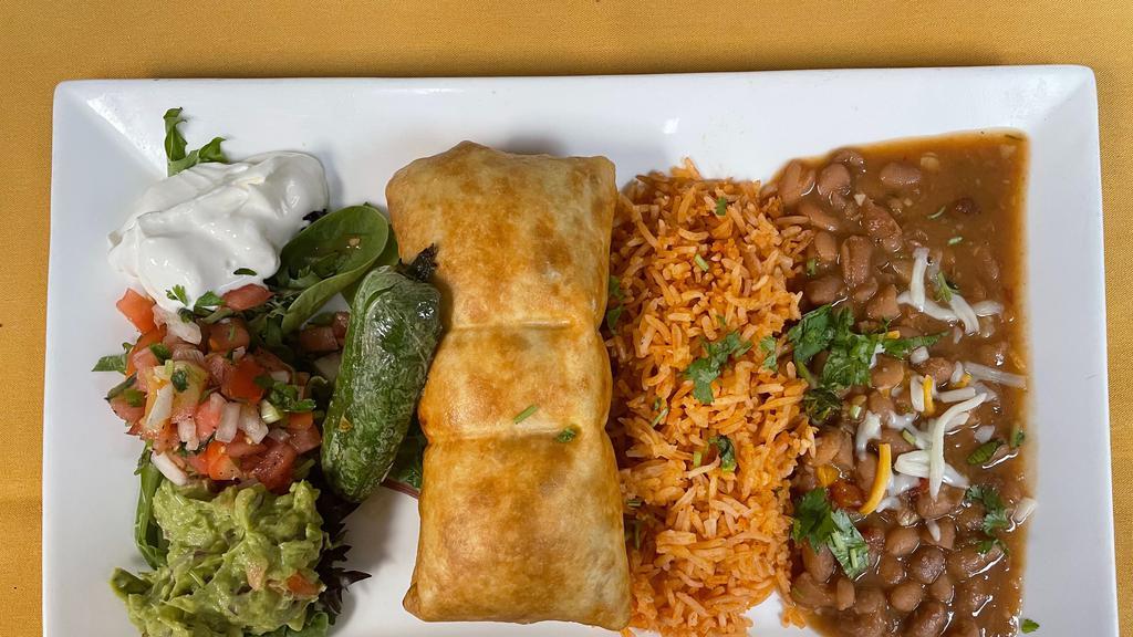 Chimichanga  · A large flour tortilla rolled with shrimp, beef or chicken then fried served with refried beans, Mexican rice, Guacamole, pico de Gallo and sour cream