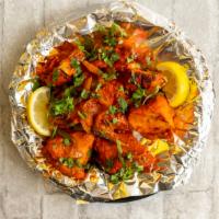 Chicken Tikka · Cubes of marinated Boneless chicken cooked in tandoor oven topped with green peppers and oni...