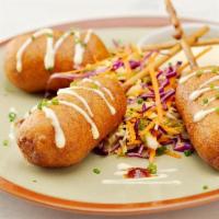 Lobster Corn Dogs · Lobster and shrimp mousse skewers rolled in homemade corndog batter and fried. Served with a...