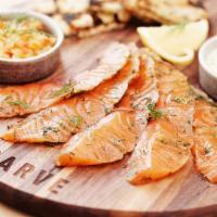 Vodka Dill Cured Salmon* · Atlantic salmon marinated in vodka and dill, thinly sliced and served with grilled country b...