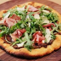 Prosciutto Fig Pizza · A homemade beer dough topped with Mission Figs, Fig Jam, Prosciutto, fresh mozzarella, shave...