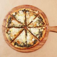 Spinach Artichoke Pizza · Pizza topped with spinach, roasted garlic, artichoke quarters and shaved Parmesan.