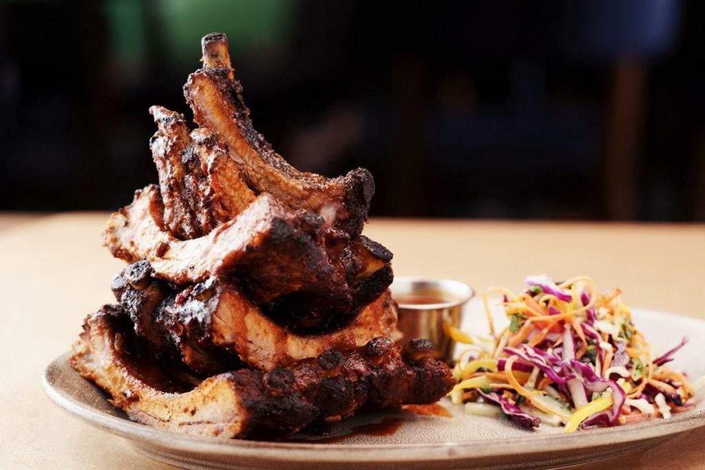 Mesquite-Grilled Baby Back Rib Tower | Gf · Homemade BBQ sauce basted on the ribs and complemented by a multi-color slaw with a light, creamy vinaigrette. Served with a side of BBQ sauce.